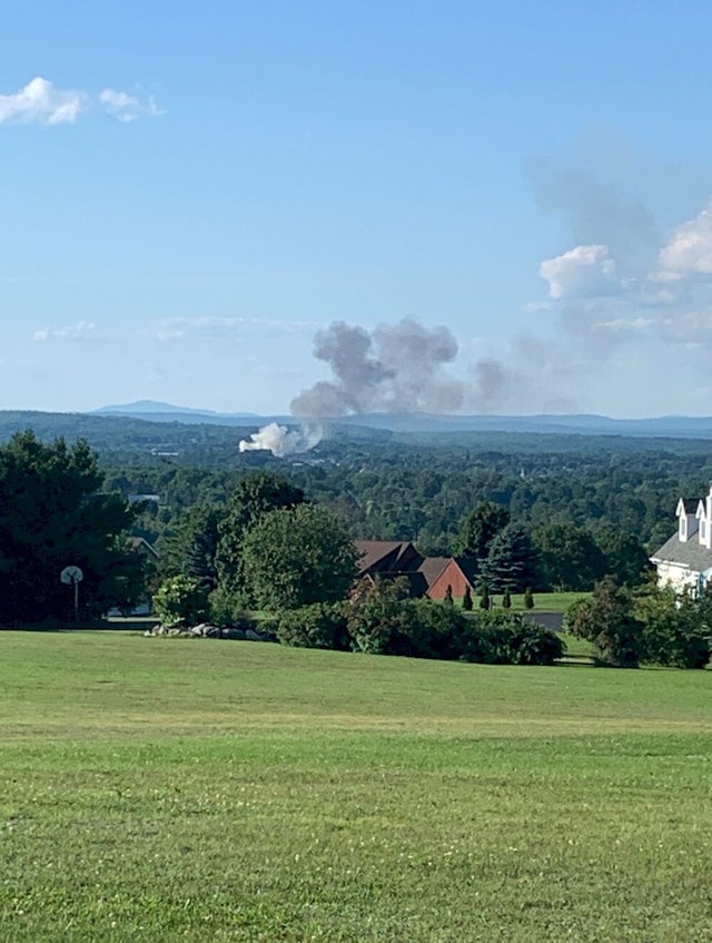 227 Back Rd, Skowhegan, ME 04976 - view of mountain backdrop featuring a heavily wooded area