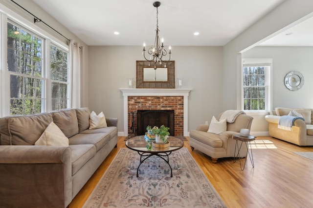 24 Cottagewood Ln, Kennebunk, ME 04043 - living room featuring wood finished floors, recessed lighting, a fireplace, and a chandelier