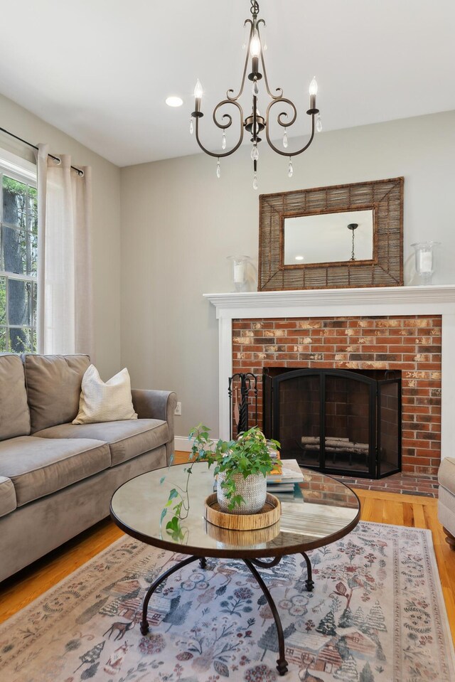 24 Cottagewood Ln, Kennebunk, ME 04043 - living area featuring a fireplace, wood finished floors, a chandelier, and recessed lighting