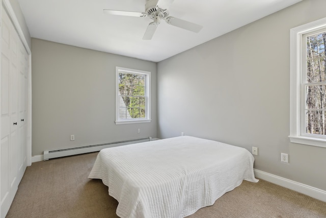 24 Cottagewood Ln, Kennebunk, ME 04043 - carpeted bedroom featuring a baseboard radiator, a closet, and ceiling fan