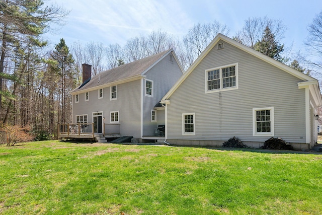 24 Cottagewood Ln, Kennebunk, ME 04043 - rear view of property with a chimney, a deck, and a lawn