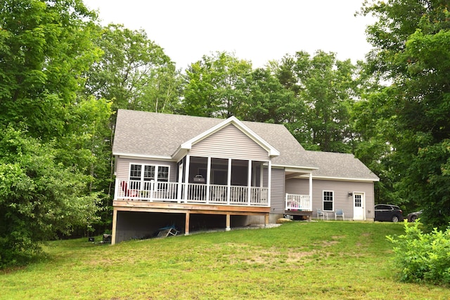 171 Hancock Pond Rd, Sebago, ME 04029 - rear view of house with roof with shingles, a yard, a sunroom, view of wooded area, and a deck
