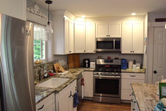 171 Hancock Pond Rd, Sebago, ME 04029 - kitchen with stainless steel appliances, white cabinetry, dark wood-type flooring, light stone counters, and recessed lighting