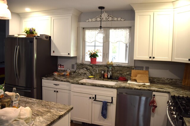 171 Hancock Pond Rd, Sebago, ME 04029 - kitchen featuring appliances with stainless steel finishes, white cabinets, pendant lighting, and dark stone counters