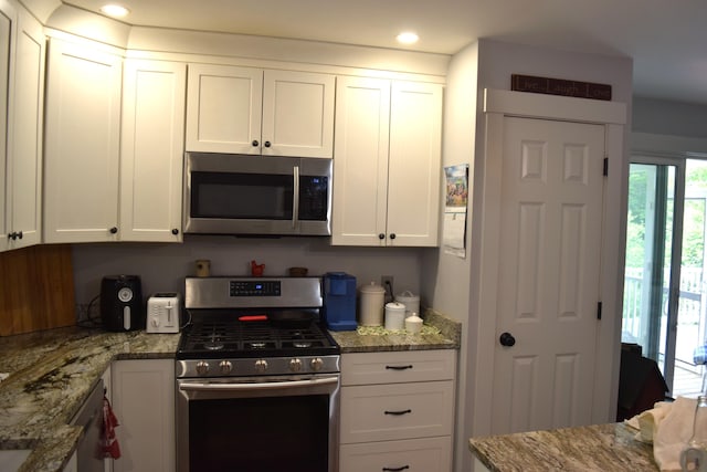 171 Hancock Pond Rd, Sebago, ME 04029 - kitchen with appliances with stainless steel finishes, white cabinetry, light stone countertops, and recessed lighting