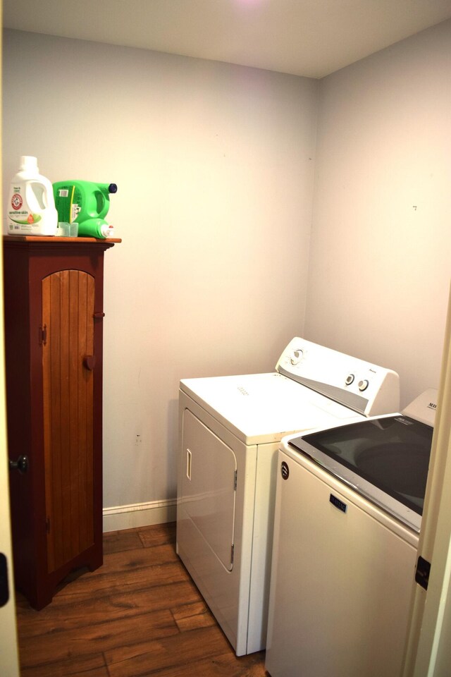 171 Hancock Pond Rd, Sebago, ME 04029 - washroom with washing machine and dryer and dark wood-style flooring