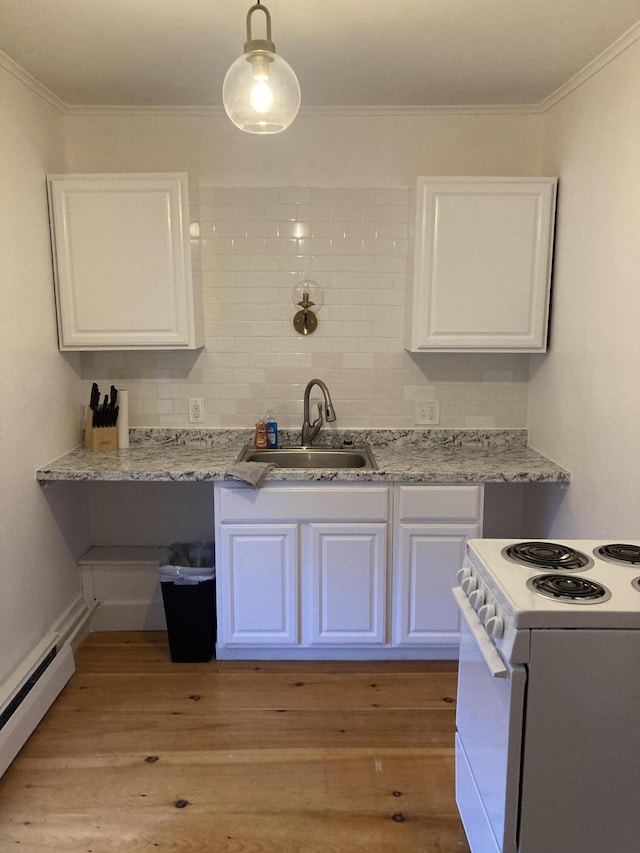 11 Gardner Ave, Machias, ME 04654 - kitchen with white range with electric stovetop, white cabinets, a baseboard radiator, ornamental molding, and light wood-type flooring