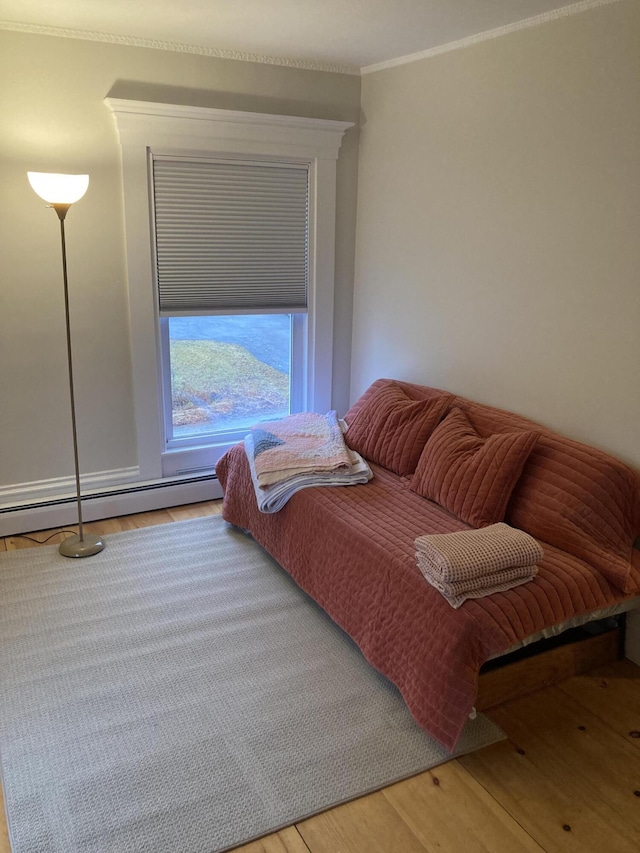 11 Gardner Ave, Machias, ME 04654 - sitting room with wood finished floors, a baseboard radiator, and crown molding