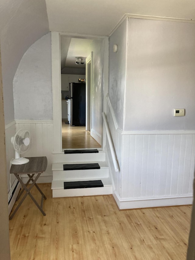 11 Gardner Ave, Machias, ME 04654 - stairs with wood finished floors, wainscoting, and a baseboard radiator