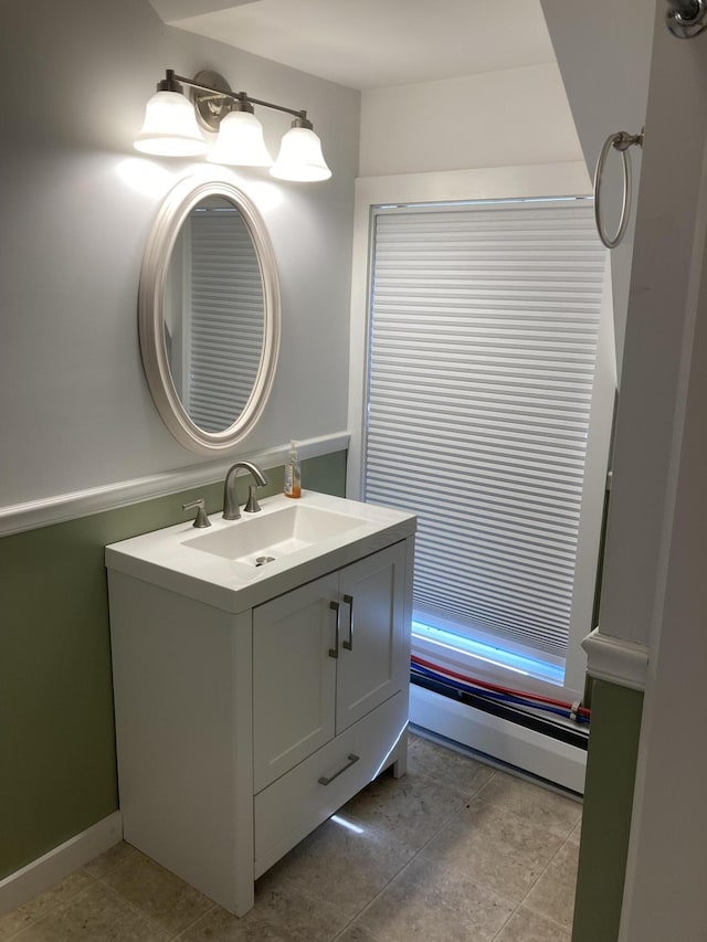 11 Gardner Ave, Machias, ME 04654 - bathroom featuring baseboard heating, vanity, and tile patterned flooring