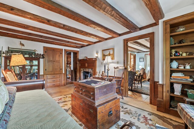 507 Ford Quint Rd, North Berwick, ME 03906 - living room featuring a fireplace, beam ceiling, and light wood-type flooring