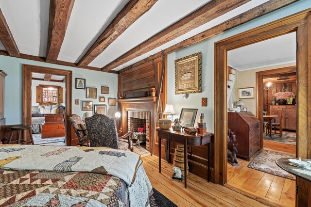 507 Ford Quint Rd, North Berwick, ME 03906 - bedroom featuring light wood-style flooring, a brick fireplace, and beam ceiling