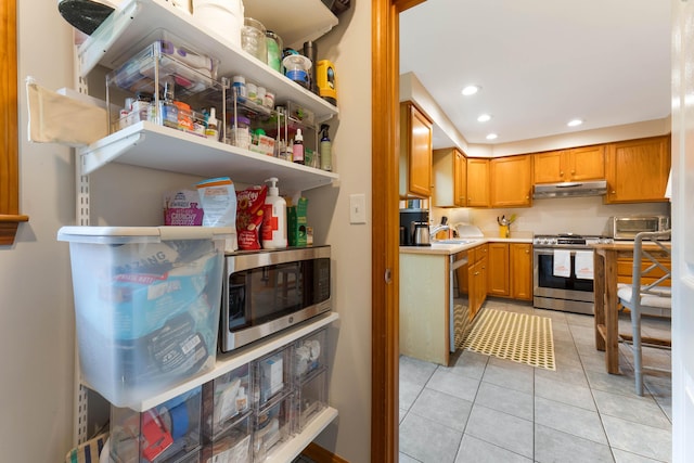 26 Ferncroft Rd, York, ME 03909 - kitchen with stainless steel appliances, under cabinet range hood, light countertops, light tile patterned flooring, and recessed lighting