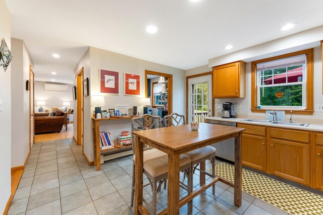 26 Ferncroft Rd, York, ME 03909 - kitchen featuring stainless steel dishwasher, a wall unit AC, light countertops, light tile patterned flooring, and recessed lighting