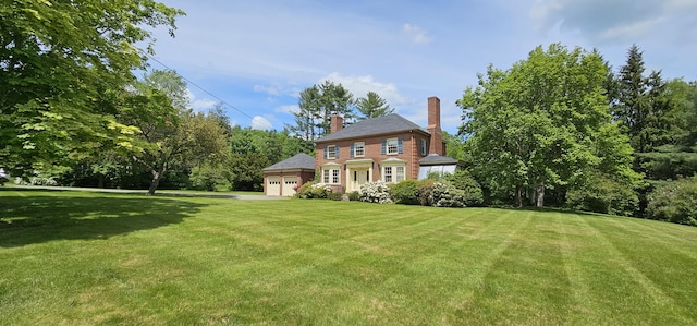 91 Mayflower Hill Dr, Waterville, ME 04901 - rear view of house featuring an attached garage, a yard, and a chimney