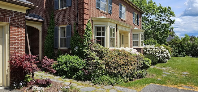 91 Mayflower Hill Dr, Waterville, ME 04901 - view of property exterior featuring brick siding and a lawn