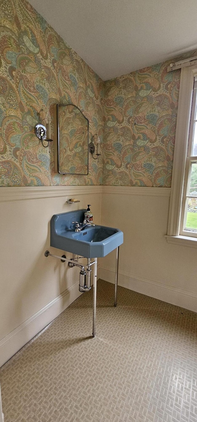 91 Mayflower Hill Dr, Waterville, ME 04901 - bathroom with a wainscoted wall and wallpapered walls