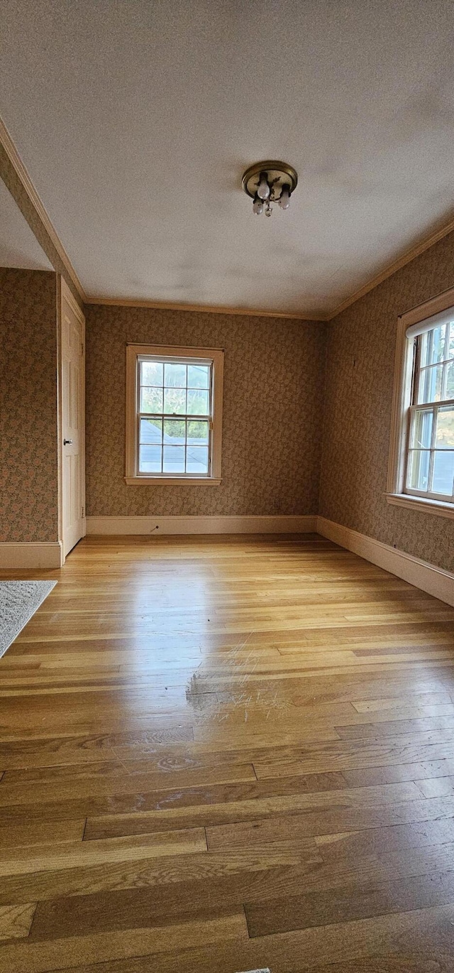91 Mayflower Hill Dr, Waterville, ME 04901 - unfurnished room with healthy amount of natural light, light wood-type flooring, a textured ceiling, wallpapered walls, and ornamental molding