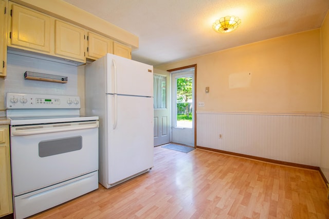 24 Down E Ln, Scarborough, ME 04074 - kitchen with white appliances, light wood-style floors, light countertops, a wainscoted wall, and backsplash