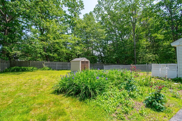 24 Down E Ln, Scarborough, ME 04074 - fenced backyard with a storage shed and view of scattered trees