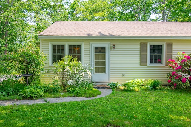 24 Down E Ln, Scarborough, ME 04074 - view of front of house featuring a front yard and a shingled roof