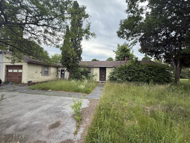13 Mount Desert Dr, Bangor, ME 04401 - view of front facade with an attached garage and driveway