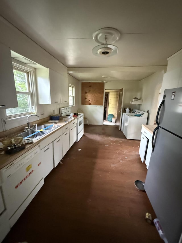 13 Mount Desert Dr, Bangor, ME 04401 - kitchen with white appliances, washer and clothes dryer, white cabinetry, dark wood-type flooring, and light countertops