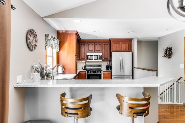 627 Green Lake Rd, Dedham, ME 04429 - kitchen featuring stainless steel appliances, a peninsula, recessed lighting, light countertops, and a kitchen breakfast bar