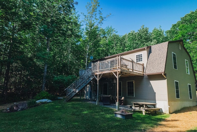 627 Green Lake Rd, Dedham, ME 04429 - rear view of house featuring a wooden deck, stairs, a lawn, and a gambrel roof