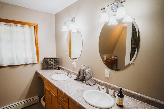 627 Green Lake Rd, Dedham, ME 04429 - bathroom with baseboard heating and double vanity