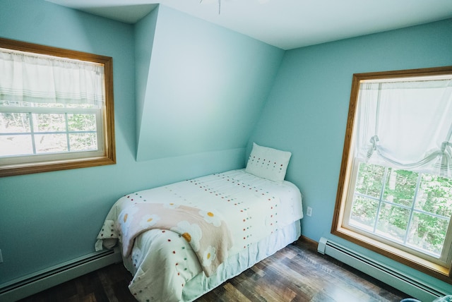 627 Green Lake Rd, Dedham, ME 04429 - bedroom featuring a baseboard radiator, multiple windows, and wood finished floors