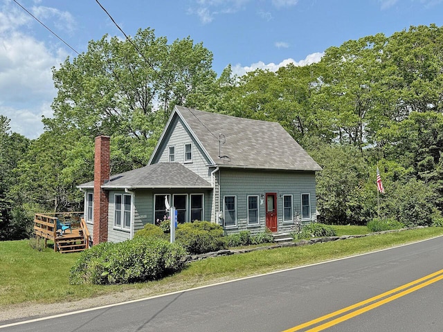 99 Huddle Rd, Bristol, ME 04554 - view of front of property with a chimney, a shingled roof, a wooden deck, and a front lawn