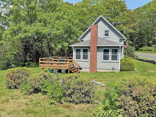 99 Huddle Rd, Bristol, ME 04554 - view of side of home featuring a wooden deck, a shingled roof, a lawn, and a forest view
