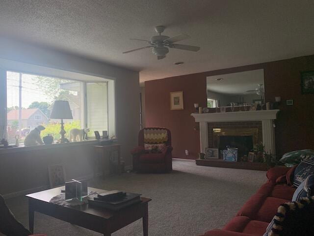 48 13th St, Bangor, ME 04401 - living room with ceiling fan, a fireplace with raised hearth, and carpet floors