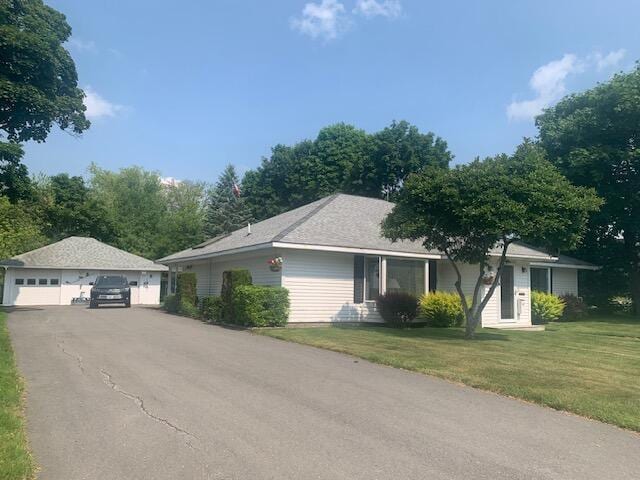48 13th St, Bangor, ME 04401 - view of front of property with a garage, an outbuilding, and a front yard