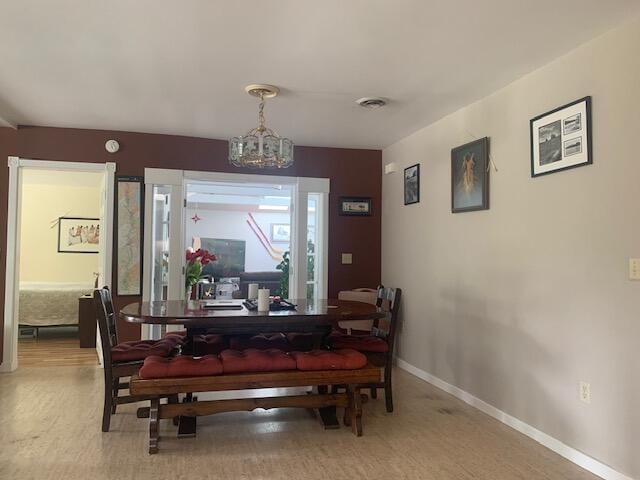 48 13th St, Bangor, ME 04401 - dining area with a chandelier and baseboards