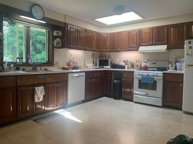48 13th St, Bangor, ME 04401 - kitchen with white appliances, under cabinet range hood, and light countertops