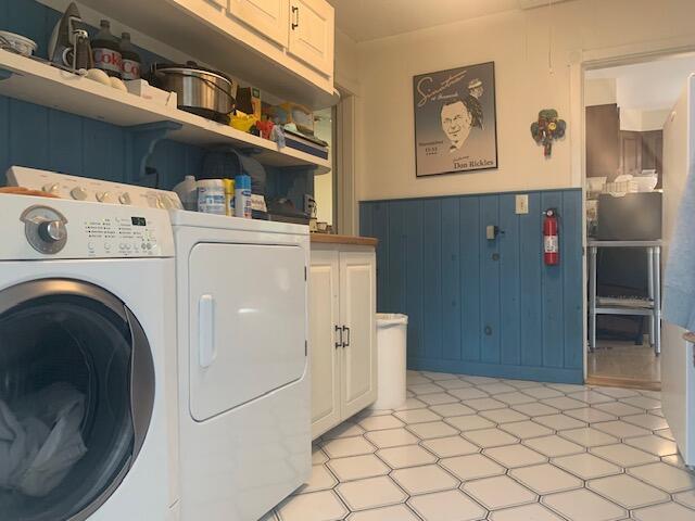 48 13th St, Bangor, ME 04401 - laundry room with cabinet space, washer and dryer, and a wainscoted wall