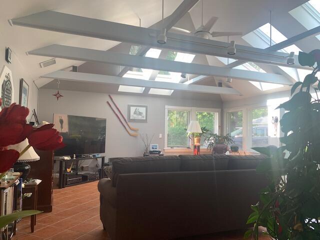 48 13th St, Bangor, ME 04401 - living room featuring a skylight, tile patterned floors, and ceiling fan