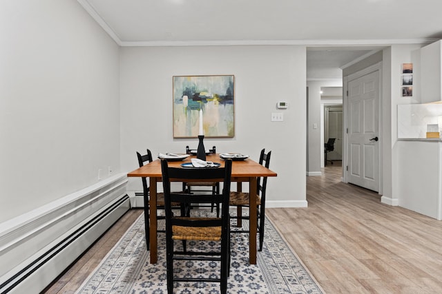 16 Guilford Ct Unit B1, Portland, ME 04101 - dining room featuring a baseboard heating unit, light wood finished floors, and crown molding