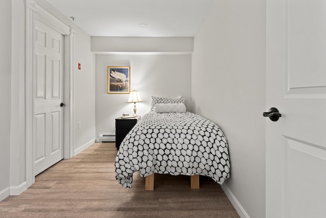 16 Guilford Ct Unit B1, Portland, ME 04101 - bedroom with wood finished floors and a baseboard radiator