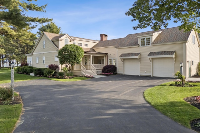 22 Channel Cove Ln, Biddeford, ME 04005 - shingle-style home featuring asphalt driveway, a porch, a chimney, roof with shingles, and an attached garage
