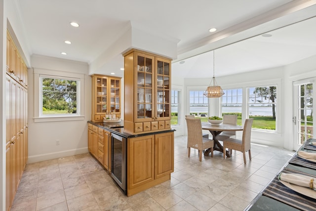 22 Channel Cove Ln, Biddeford, ME 04005 - kitchen with wine cooler, healthy amount of natural light, glass insert cabinets, recessed lighting, and dark countertops
