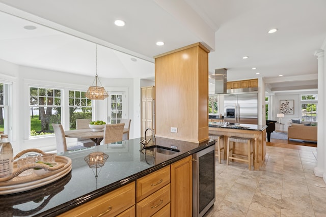 22 Channel Cove Ln, Biddeford, ME 04005 - kitchen with built in refrigerator, dark stone countertops, recessed lighting, wine cooler, and pendant lighting
