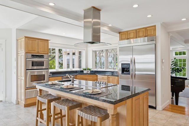 22 Channel Cove Ln, Biddeford, ME 04005 - kitchen with appliances with stainless steel finishes, island exhaust hood, a warming drawer, an island with sink, and recessed lighting