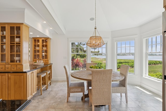 22 Channel Cove Ln, Biddeford, ME 04005 - dining area featuring a chandelier, lofted ceiling, light tile patterned floors, recessed lighting, and a water view