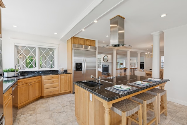 22 Channel Cove Ln, Biddeford, ME 04005 - kitchen featuring stainless steel built in refrigerator, decorative columns, a kitchen breakfast bar, island range hood, and open floor plan