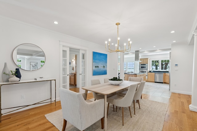 22 Channel Cove Ln, Biddeford, ME 04005 - dining room with a chandelier, recessed lighting, light wood-type flooring, crown molding, and decorative columns