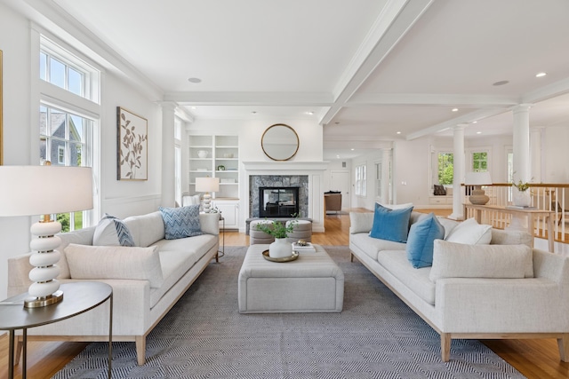 22 Channel Cove Ln, Biddeford, ME 04005 - living room featuring decorative columns, healthy amount of natural light, wood finished floors, recessed lighting, and beam ceiling