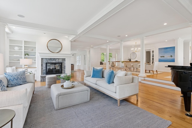 22 Channel Cove Ln, Biddeford, ME 04005 - living room featuring decorative columns, light wood finished floors, beam ceiling, a high end fireplace, and recessed lighting